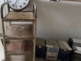 a clock that is on a shelf in a room