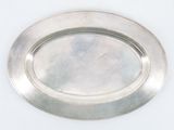 a silver plate on a white table with a white background