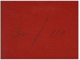 a close up of a red piece of paper with writing on it