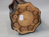 a brown and black vase with gears on it