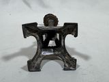 a small metal object that is sitting on a white surface