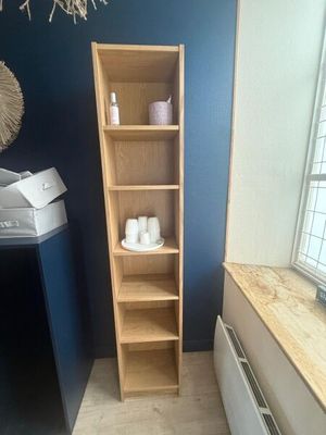 a wooden shelf in the corner of a room