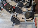 a row of stationary exercise bikes in a gym