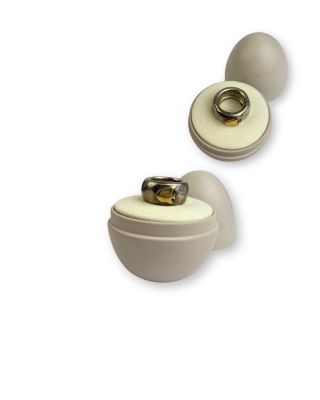 une paire de boutons en céramique blanche, chacun orné d'un anneau doré