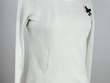 the shirt is white and has a black flower on it