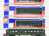 three green train cars are stacked on top of each other