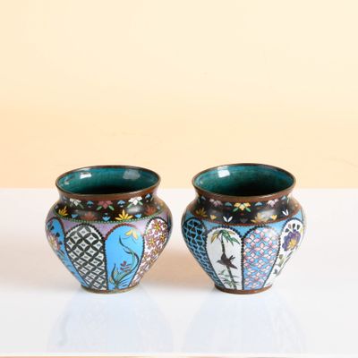 two vases that are sitting on a table