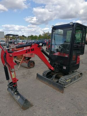 an image of a small excavator parked in a lot