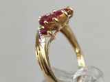 an image of a close up of a gold ring with a ruby stone