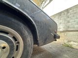 a black car that is parked on the side of the road