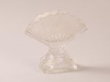 a clear glass vase with a scallop design on it
