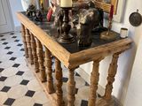 a table with a lamp and a statue on it
