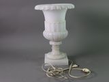 a white vase that is sitting on a table