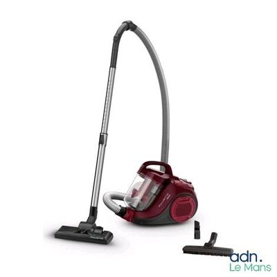 a red vacuum cleaner is sitting next to a black and white vacuum