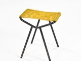 a yellow stool with black legs and a woven seat