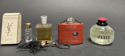 three perfume bottles and a box of perfume on a table