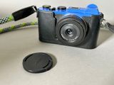 a black camera with a blue camera strap and a black camera