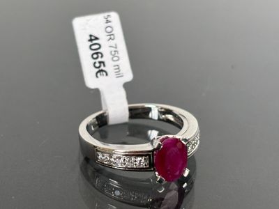 an image of a ruby and diamond ring on a table