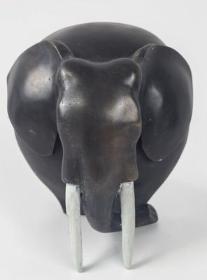 statue of an elephant with tusks on a white background