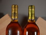 two bottles of wine sitting next to each other on a table
