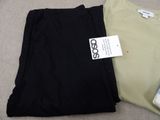 two pairs of pants and a t - shirt sitting on the floor