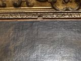 a mirror hanging on the wall with a chain