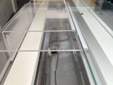 a glass display case in the middle of a store