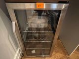 a glass door that is open on a wooden floor