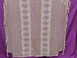 a close up of a purple blanket with a pattern on it