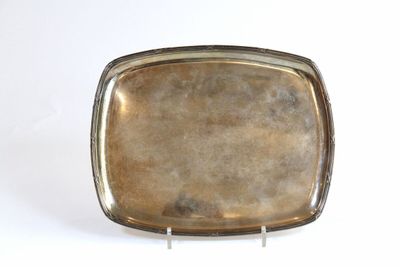 a silver tray with a silver handle on a white surface