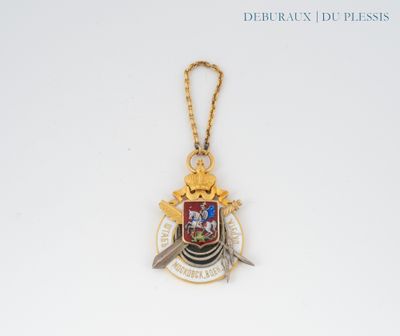 a close up of a gold medal with a sword on a chain