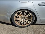 a silver car with a brown rim parked in a parking lot