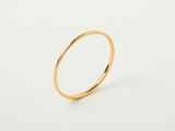 a close up of a gold ring on a white surface