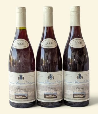 three bottles of wine sitting on top of a table next to each other
