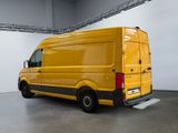 the yellow van is parked in the large room of the building