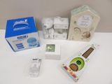 a white table with various items on it including a cell phone, toothbrush, toothpaste, toothpaste, and toothpaste