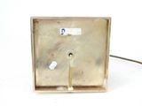 a small metal box with a wire attached to it