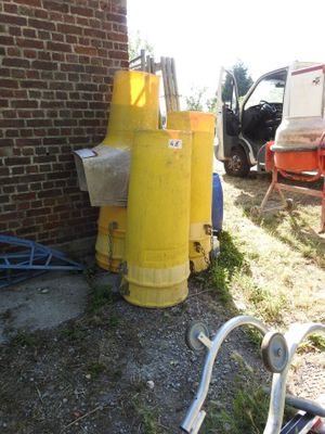 a yellow fire hydrant sitting next to a brick building