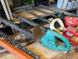 several chainsaws are sitting on a wooden table in a workshop