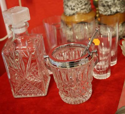 bottles and glasses on a table with a red background