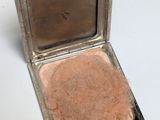 a small silver box with a mirror on it