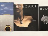 three books of bulgari jewelry on a white surface