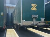 two trucks that are parked next to each other in a parking lot