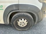 a white van with a flat tire on the street