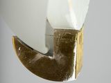 a close up of a white toilet with a gold handle