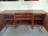 an image of a wooden desk with drawers and shelves