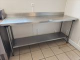 a stainless steel counter in a kitchen with a microwave