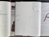 an open book with a drawing of a woman on it