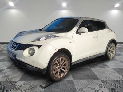 a picture of a white nissan juke suv parked in a garage