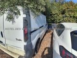 two white vans parked next to each other in a parking lot